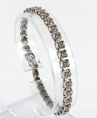 Lot 2717 - A 9ct white gold diamond tennis style bracelet,...