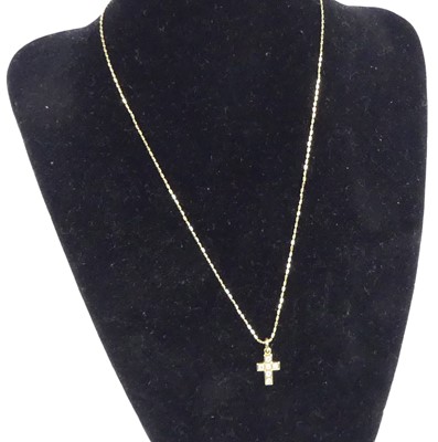 Lot 2593 - An 18ct yellow gold diamond set cross pendant,...