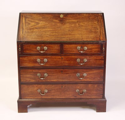 Lot 2474 - A George III mahogany slopefront writing...