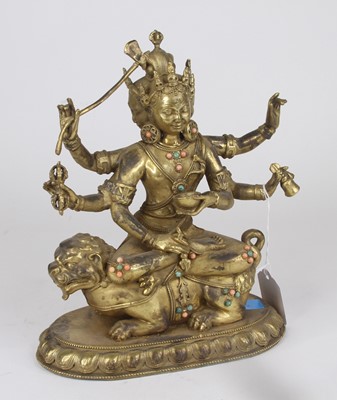 Lot 10 - A gilt metal figure of a Tibetan deity...