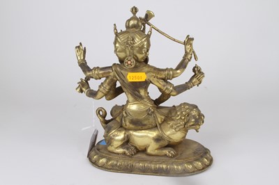 Lot 10 - A gilt metal figure of a Tibetan deity...