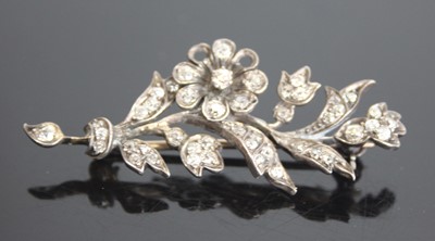 Lot 2567 - A white and yellow metal diamond floral spray...