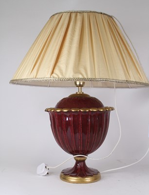 Lot 27 - A red and gilt glazed pottery table lamp in...