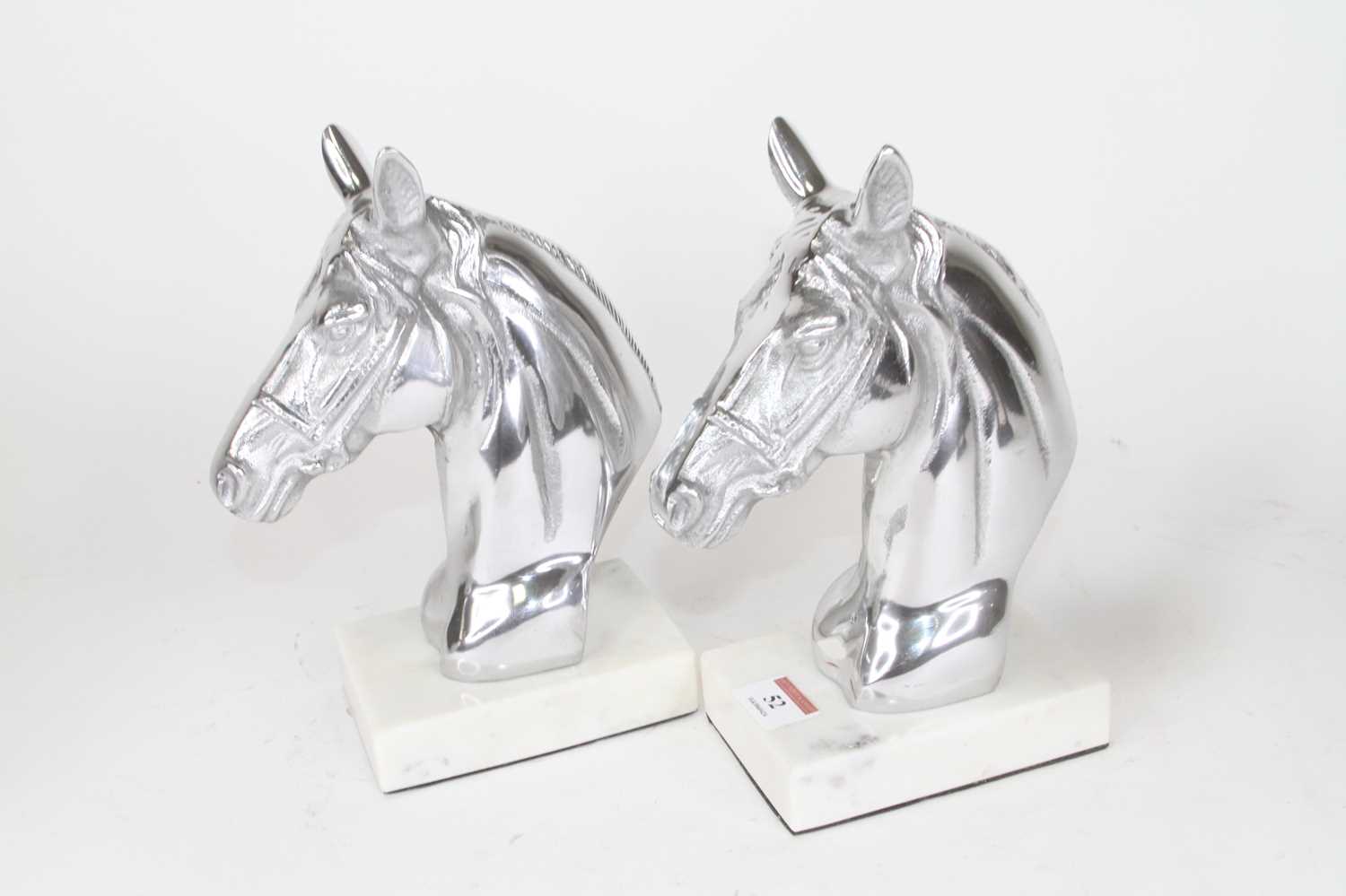 Lot 52 - A pair of polished metal horse head busts,...