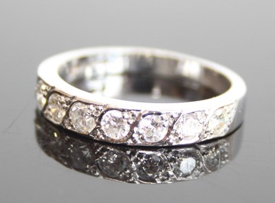 Lot 2569 - An 18ct white gold diamond half eternity ring...