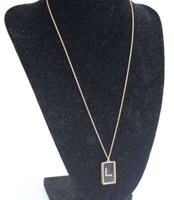Lot 2577 - A yellow metal rectangular glass pendant with...