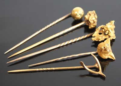 Lot 2582 - Five assorted yellow metal stick pins to...