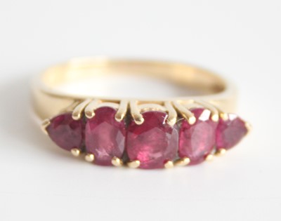 Lot 2597 - A 14ct yellow gold ruby half hoop eternity...