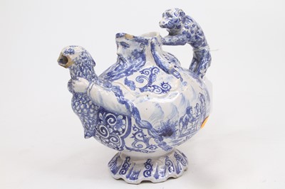 Lot 213 - An 18th century Delft blue and white teapot,...