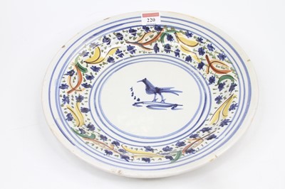 Lot 220 - A French faience polychrome charger, decorated...