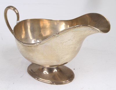 Lot 300 - An Elizabeth II silver helmet shaped sauceboat,...