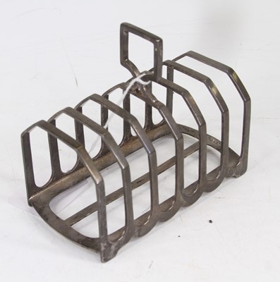 Lot 302 - A George VI silver six-division toast rack,...