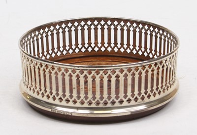 Lot 356 - A pierced silver and turned wood wine coaster,...