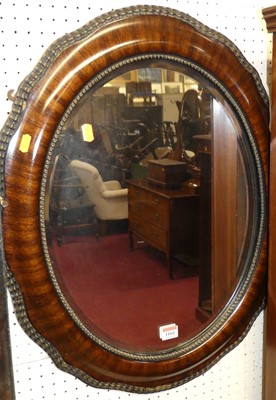 Lot 1164 - An early 20th century oval bevelled wall...