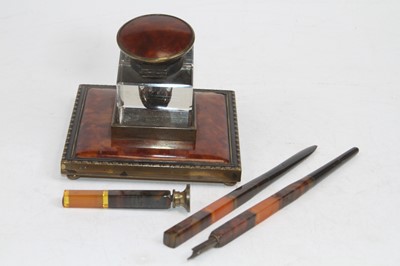 Lot 512 - A simulated tortoiseshell and brass inkwell;...