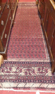 Lot 1185 - A Persian woollen red ground Bokhara rug, the...