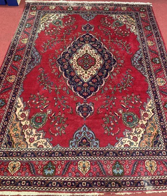 Lot 1195 - A large Persian woollen red ground Shiraz rug,...