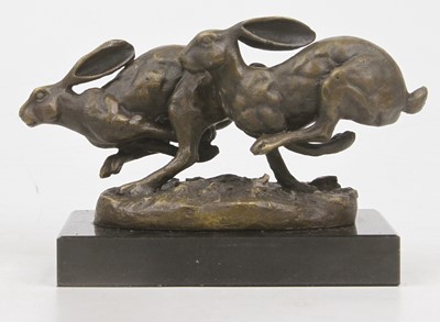 Lot 580 - A bronzed model of running hares, mounted upon...