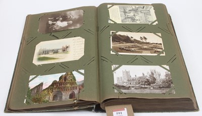 Lot 591 - A vintage postcard album and contents,...