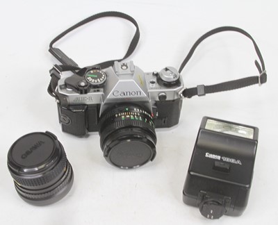 Lot 593 - A Canon AE1 SLR camera; together with various...