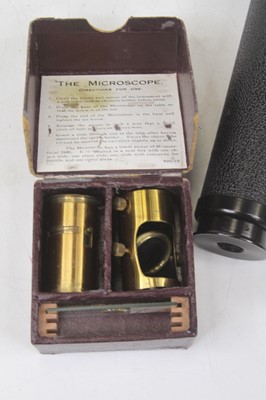 Lot 604 - A vintage brass student's microscope; together...