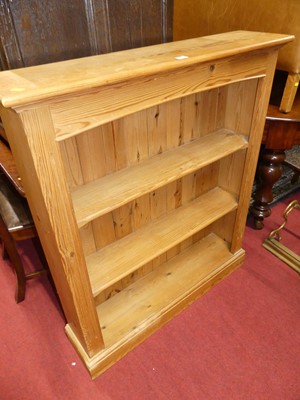 Lot 1311 - A modern pine low freestanding open bookshelf,...