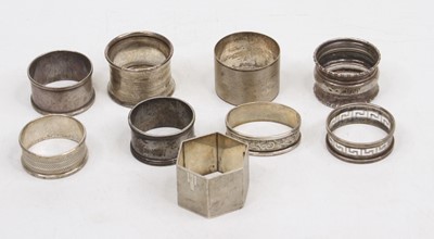 Lot 329 - A collection of nine silver napkin rings, 5.7ozt