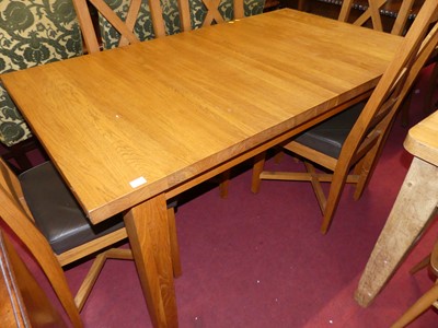 Lot 1360 - A contemporary joined honey oak dining suite,...