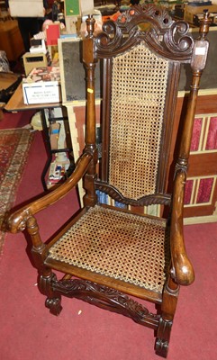 Lot 1376 - A walnut cane back and seat open armchair, in...