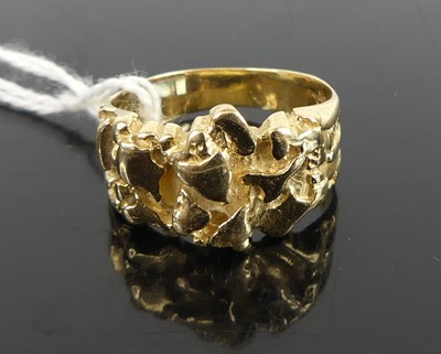 Lot 401 - A yellow metal carved gold band ring, stamped...