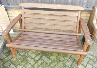 Lot 1463 - A stained and slatted wood two-seater garden...