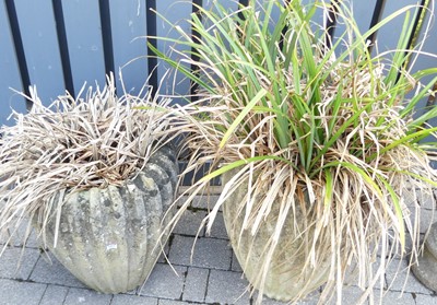 Lot 1469 - A pair of reconstituted stone planters, each...