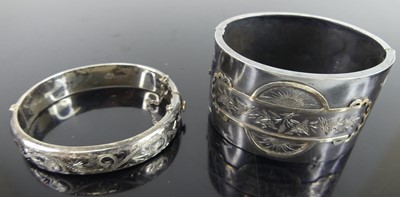 Lot 432 - A silver and engraved hinged bangle; together...