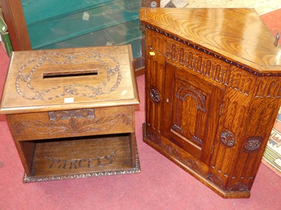 Lot 1423 - A relief carved oak table top parcel box, with...