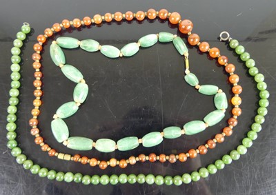 Lot 448 - A beaded nephrite necklace; together with one...