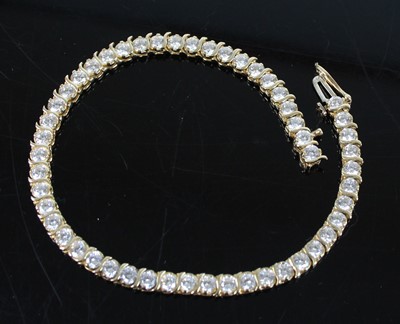 Lot 2602 - A yellow metal cubic zirconia tennis bracelet,...