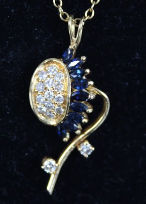 Lot 2238 - A yellow metal, sapphire and diamond pendant...