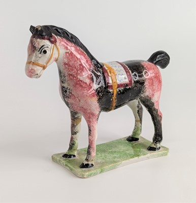 Lot 2072 - A pearlware model of a horse, probably...