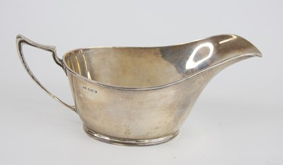 Lot 74 - An Art Deco silver sauceboat, the oval body...