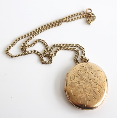 Lot 2661 - A 9ct yellow gold oval locket, engraved with a...