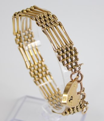 Lot 2539 - A 9ct gold gatelink bracelet, with heart...