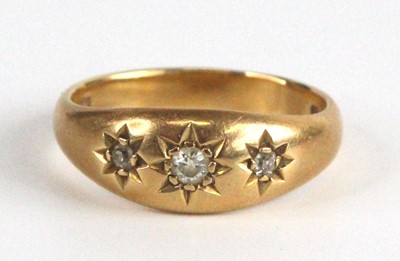 Lot 2545 - An 18ct gold diamond three-stone ring, the...