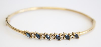 Lot 317 - A modern 9ct hollow gold, sapphire and diamond...