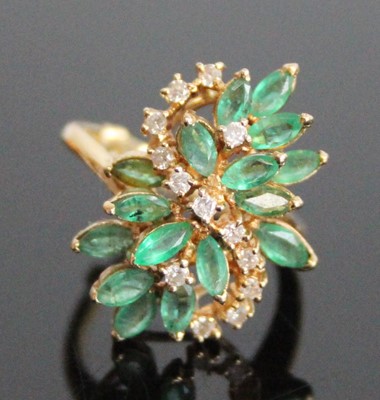 Lot 2834 - A yellow metal, emerald and diamond abstract...