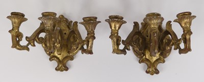 Lot 31 - A pair of carved gilt wood three branch wall...