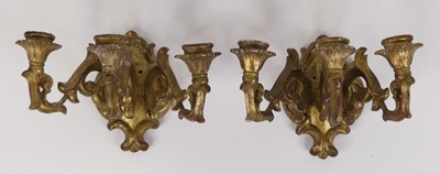 Lot 31 - A pair of carved gilt wood three branch wall...