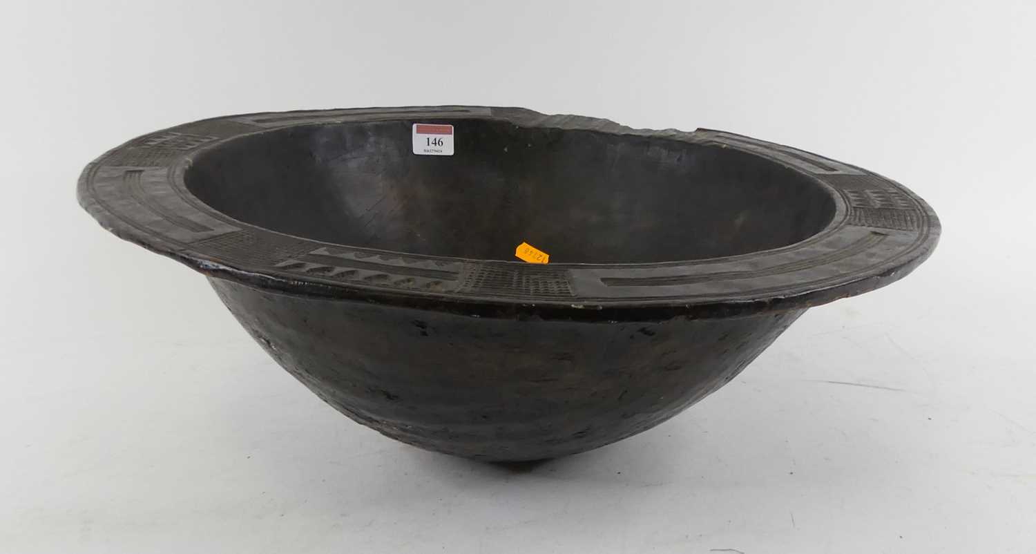 Lot 146 - A West African carved wood ceremonial bowl,...