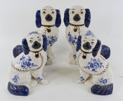 Lot 108 - A pair of Staffordshire seated spaniels of...