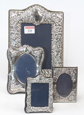 Lot 226 - A modern repousse decorated silver easel...