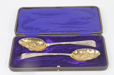 Lot 253 - A pair of George III silver berry spoons, each...